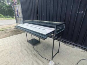 Glass display case, jewelry case, with iron legs and lights.