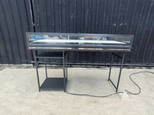 Glass display case, jewelry case, with iron legs and lights.