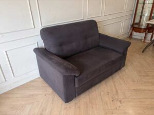 IKEA 2-seater sofa, dark grey fabric upholstery, modern style.
