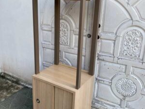 Display cabinet featuring a hanging rail and sliding-door storage compartments.