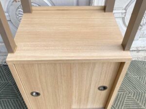 Display cabinet featuring a hanging rail and sliding-door storage compartments.
