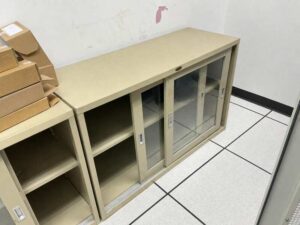 Low-profile steel filing cabinet with sliding glass doors