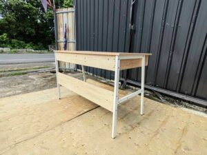 Multipurpose desk, wood grain finish, white legs.