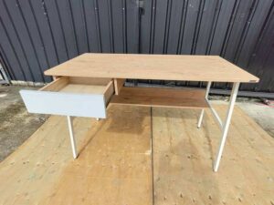 Multipurpose desk, wood grain finish, white legs.