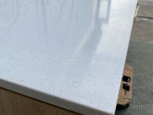 Counter with light-colored wood top, 240 cm