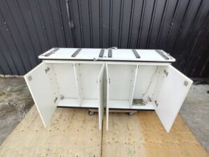 Counter cabinet, white with black trim, featuring shelving and two storage compartments. (4)