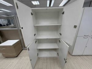 Tall white wooden filing cabinet with 4 hinged doors