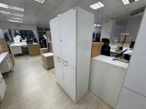 Tall white wooden filing cabinet with 4 hinged doors