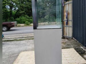 Tall white glass display cabinet with one door and two storage compartments.